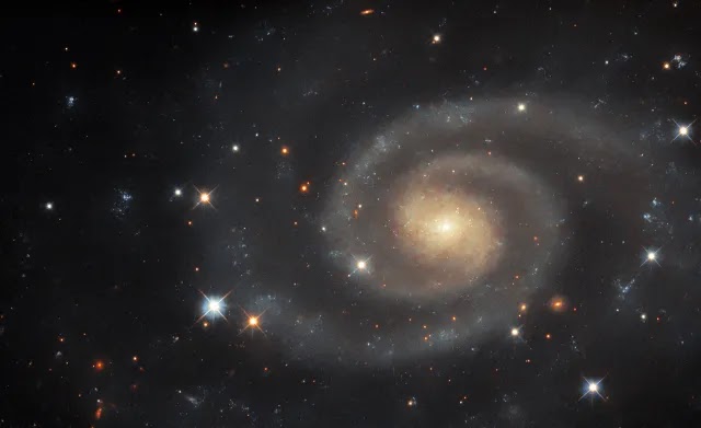 Hubble’s Glimpse: UGC 11105, a Dim yet Distinct Spiral Galaxy, Captured in Striking Detail.